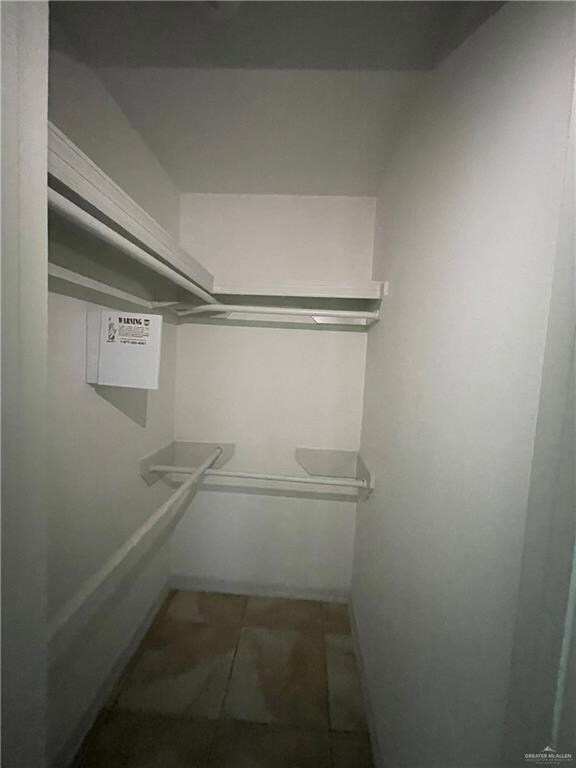 Walk in closet featuring tile patterned floors