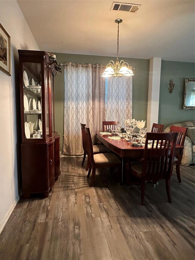 Dining room featuring an inviting chandelier and h