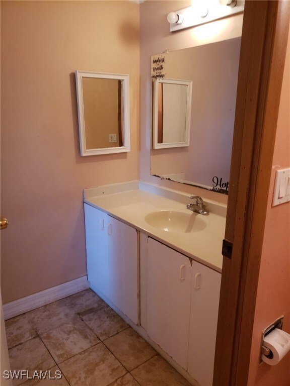 Bathroom featuring vanity, tile patterned floors,