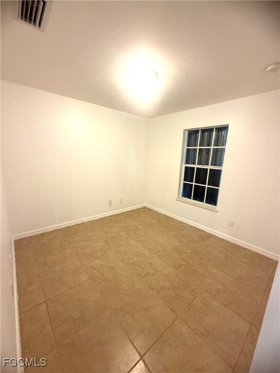 Spare room featuring baseboards