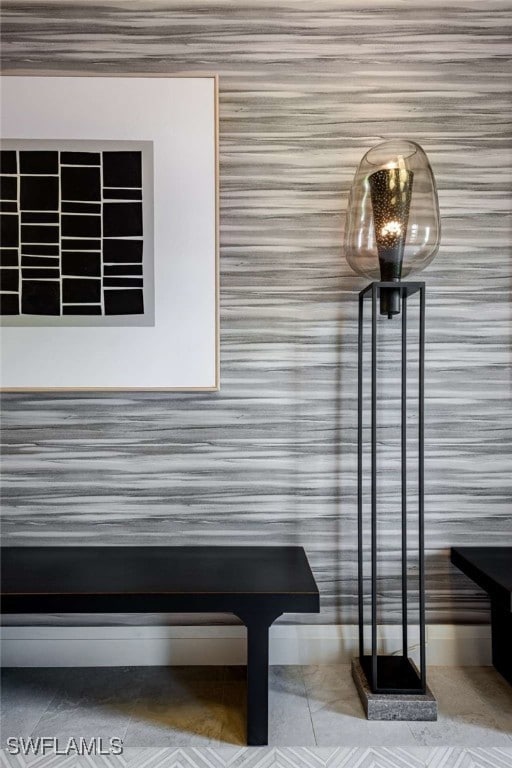 Detailed view of wallpapered walls and baseboards