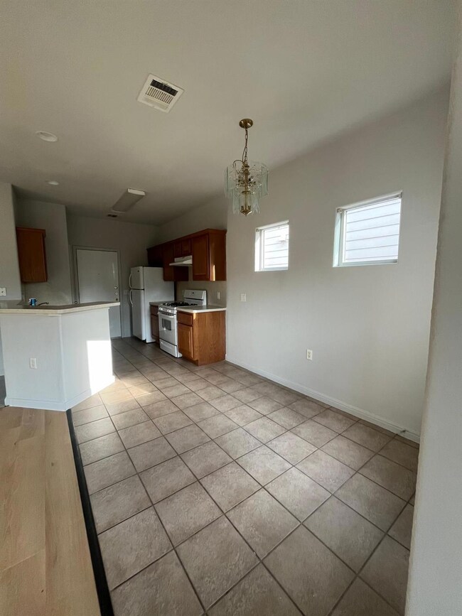 Kitchen featuring white appliances, light counter