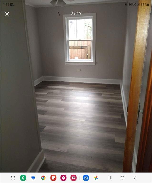 Spare room featuring ceiling fan and dark hardwood