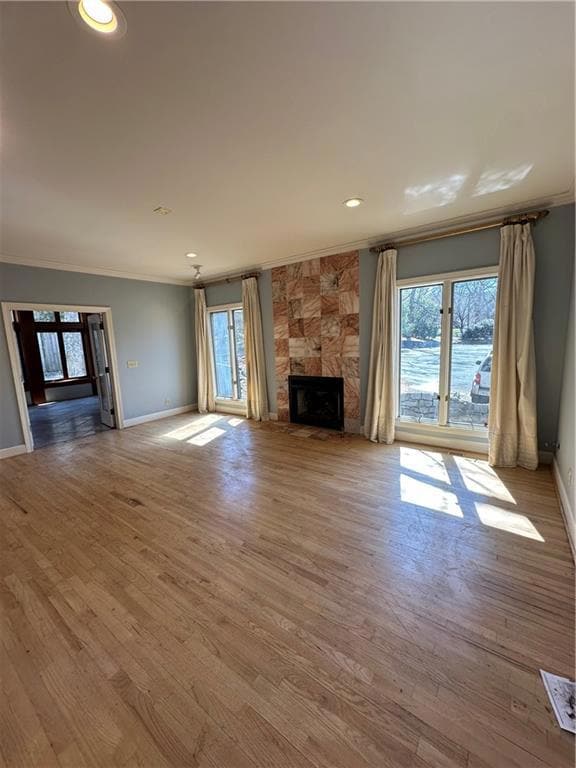 Unfurnished living room featuring wood finished fl