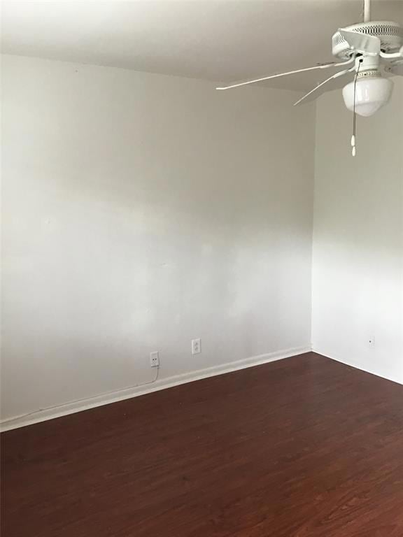 Unfurnished room with baseboards, ceiling fan, an