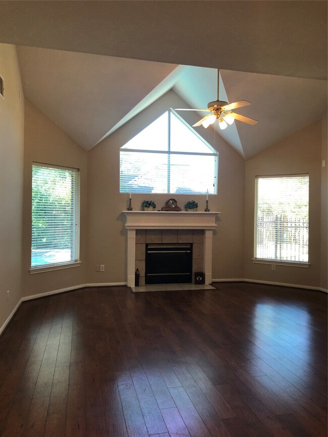 Huge Family room with soaring vaulted ceiling, wood flooring, centering around the lovely gas log fireplace, and views of your pool oasis! Family room is wired for surround sound.