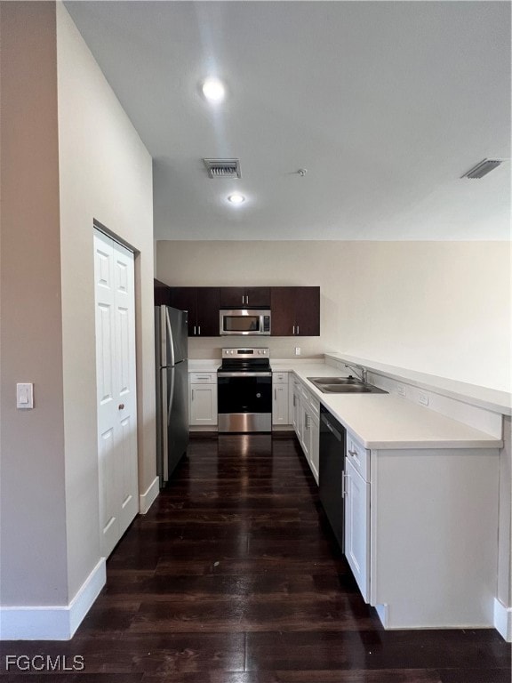 Kitchen featuring stove, dark wood-type flooring,