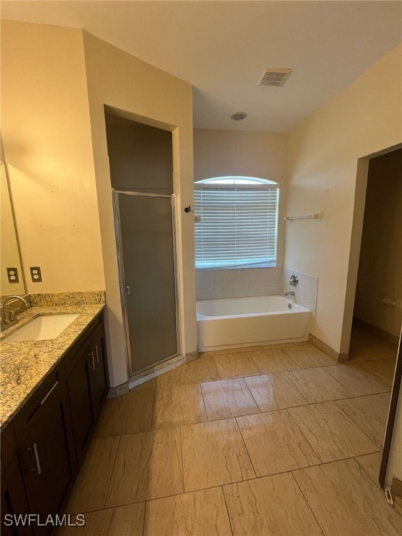 Full bath featuring a stall shower, a garden tub,