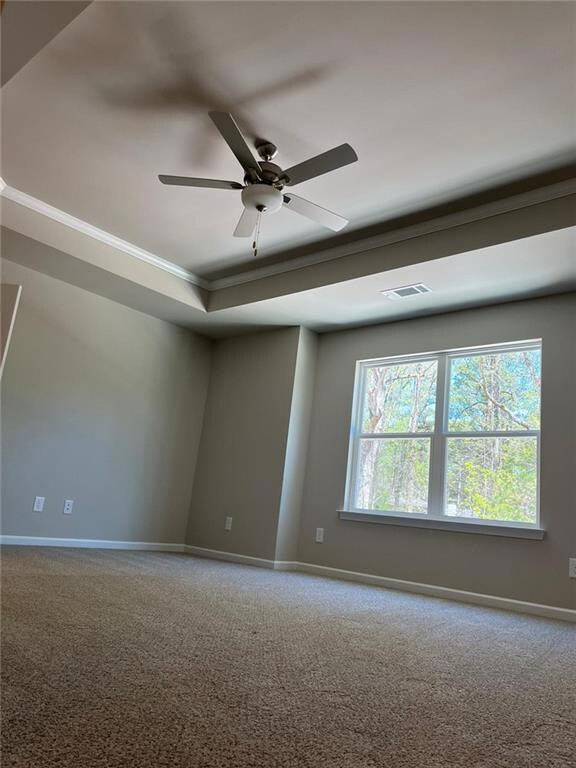 Master bedroom with carpeting, ornamental molding, baseboards, and ceiling fan