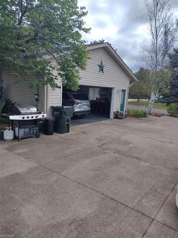 View of side of property with a garage