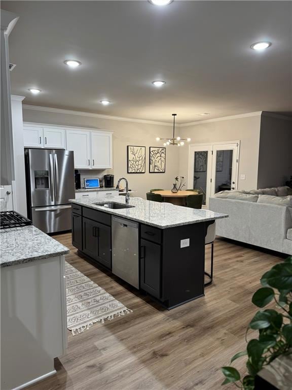 Kitchen featuring pendant lighting, sink, applianc