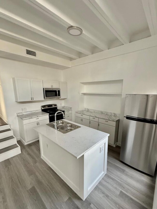 Kitchen with stainless steel appliances, beam cei