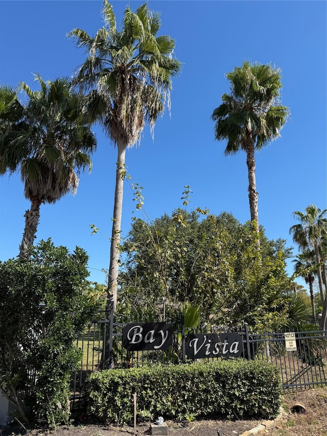 Welcoming entrance to Bay Vista, a well-maintained boutique bayfront community. This fenced-in neighborhood features mature palms, manicured landscaping, and a peaceful back set setting with convenient access to Kemah Boardwalk amenities, Galveston, and nearby attractions.