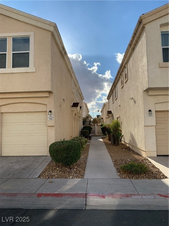 View of property exterior featuring a garage, a ga