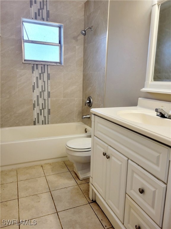 Full bathroom featuring tile patterned flooring, tiled shower / bath, vanity, and toilet