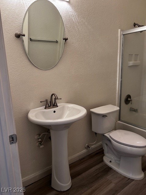 Bathroom featuring wood finished floors, baseboard