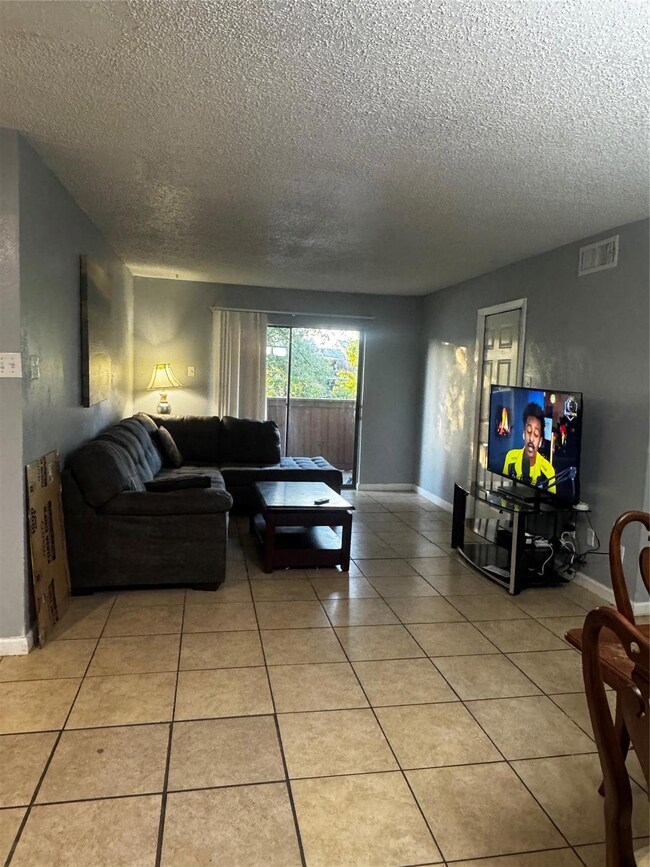 Living area featuring light tile patterned floors,