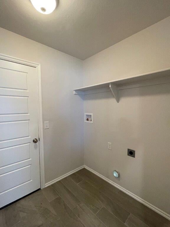 Laundry room featuring electric dryer hookup, washer hookup, and dark wood finished floors