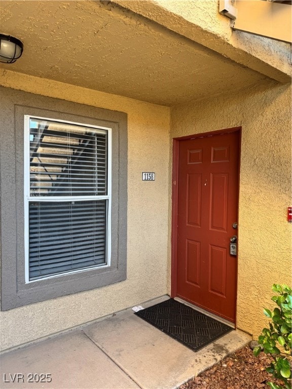 Property entrance with stucco siding