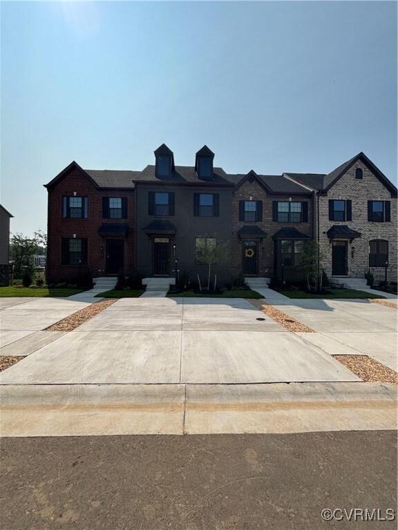 Townhome property with brick siding