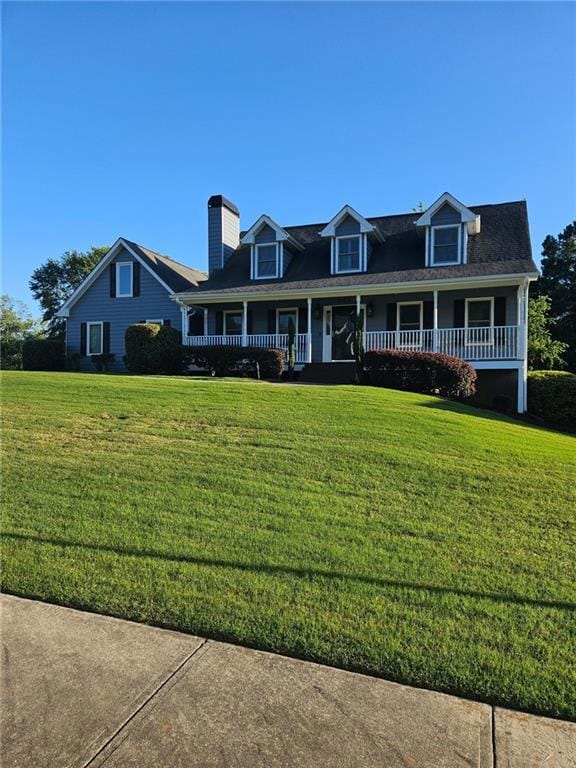 View of front of home featuring a porch and a front lawn