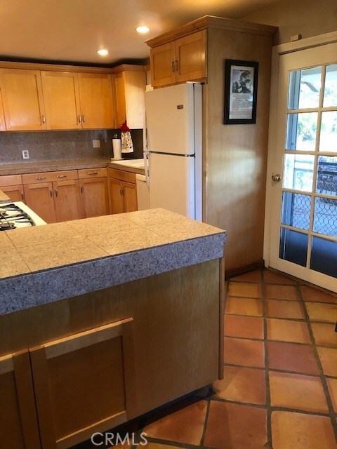 Kitchen with door leading to the outdoor patio