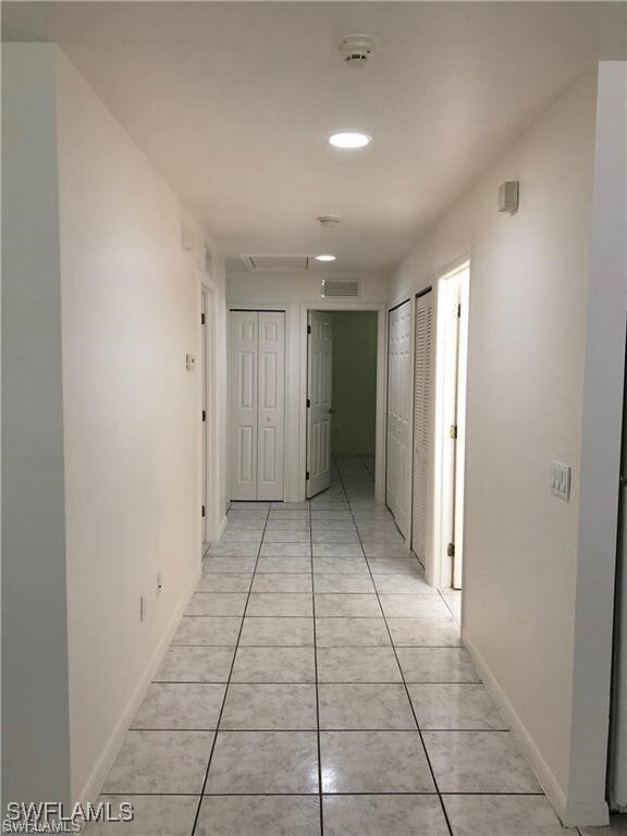 Hallway featuring light tile patterned flooring