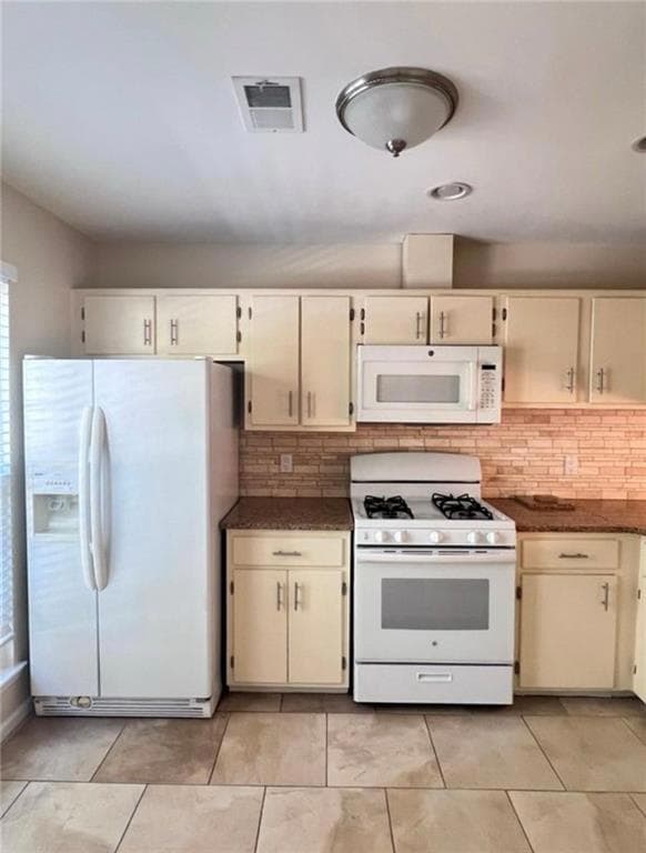 Kitchen with light tile patterned flooring, tastef