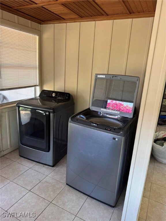 Laundry room with light tile patterned floors, sep
