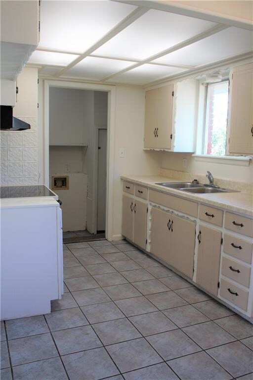 Ceramic tile and stainless steel sink. Formica cou