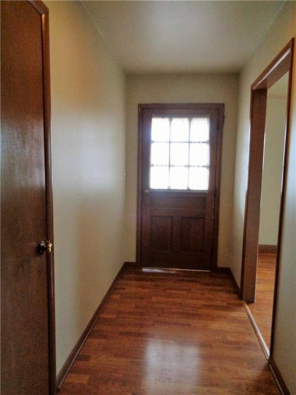 Entry with easy clean laminate flooring. Note coat