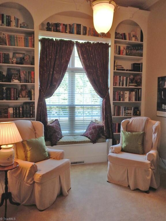 The cozy Living Room has a vaulted ceiling & built-in floor to ceiling bookcases witha window seat.