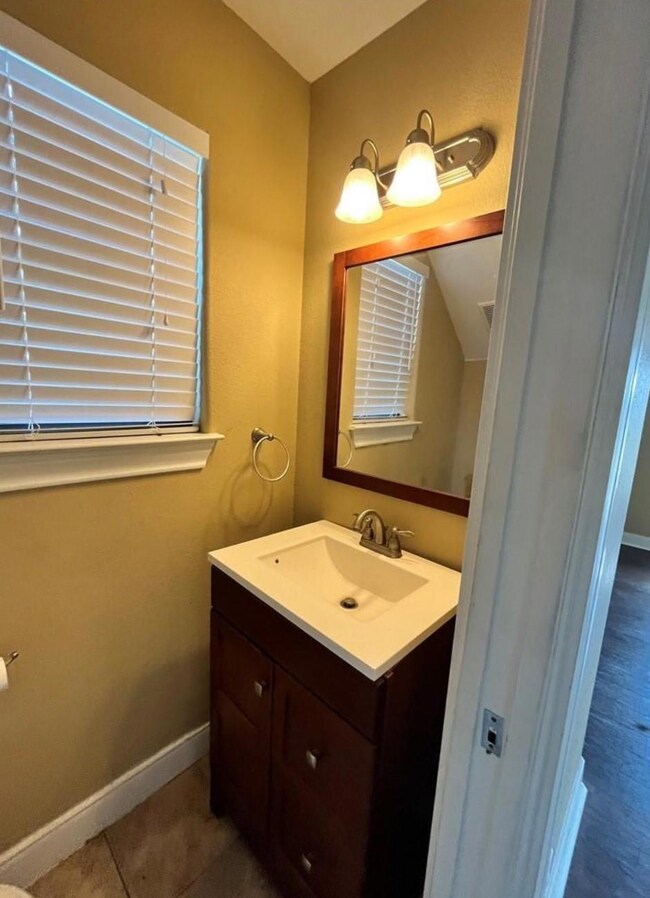 Bathroom with vanity and baseboards