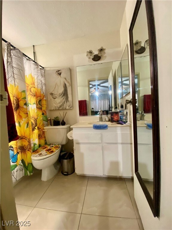 Full bathroom with tile patterned floors, toilet,