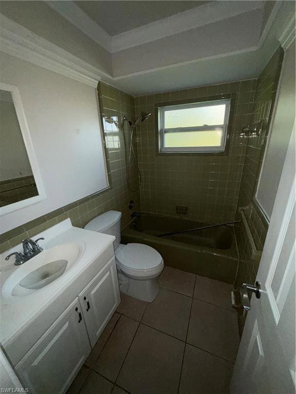 Bathroom featuring shower / bath combination, vanity, tile walls, light tile patterned floors, and ornamental molding