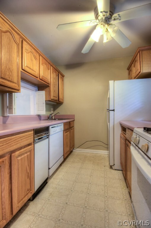 Galley kitchen with linoleum floors and ceiling fa