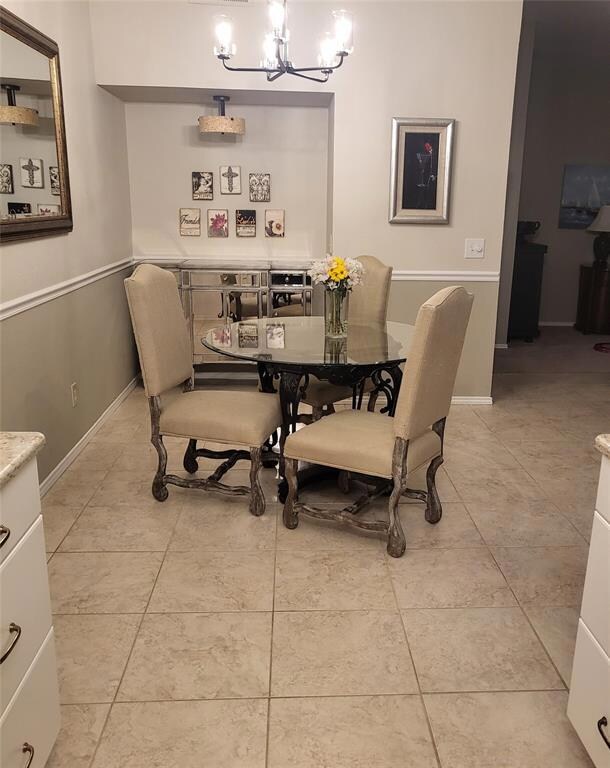 Dining area featuring a notable chandelier and lig