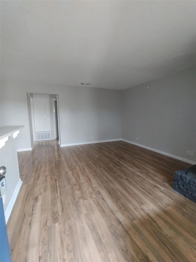 Unfurnished living room with visible vents, wood 