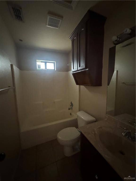 Full bathroom with tile patterned floors, vanity, toilet, and shower / bathtub combination