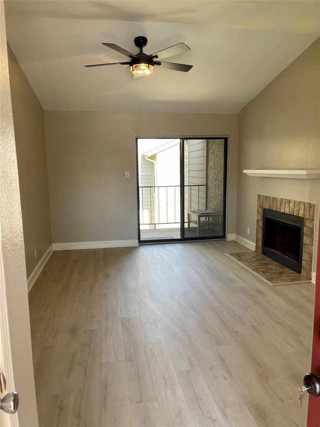 Unfurnished living room featuring a fireplace, vau