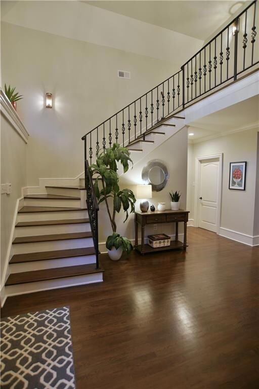The winding staircase in the foyer leads you to th