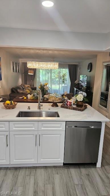 Kitchen with a sink, light stone counters, stainle
