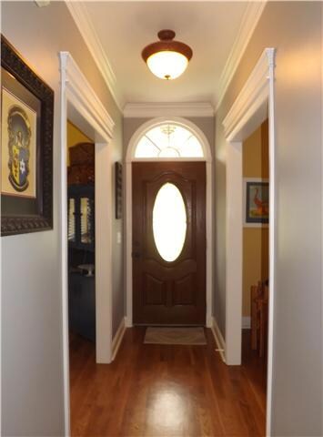 A gleaming hardwood foyer opens to this beautiful home with an office on the left and the formal dining room on the right.