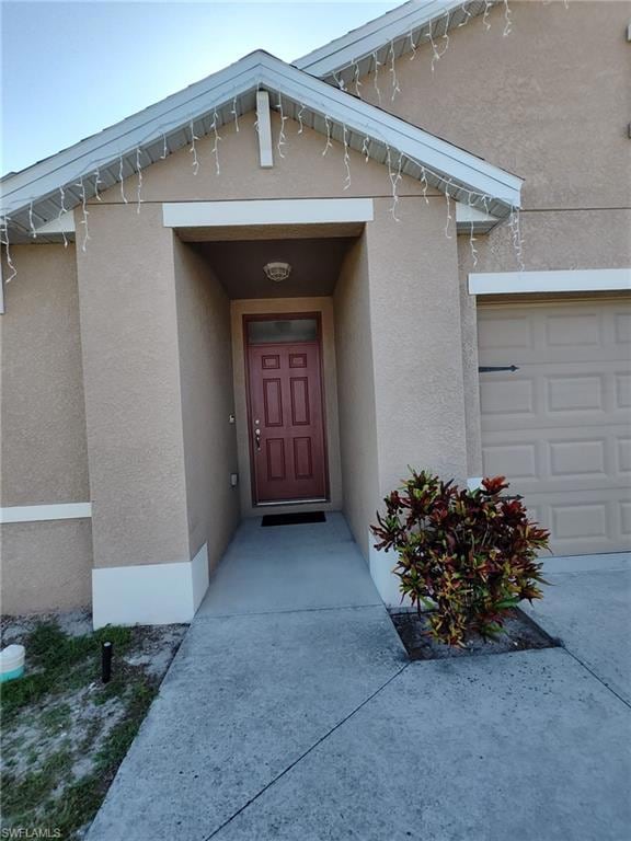 Doorway to property with stucco siding
