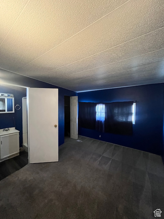 Unfurnished living room with dark colored carpet