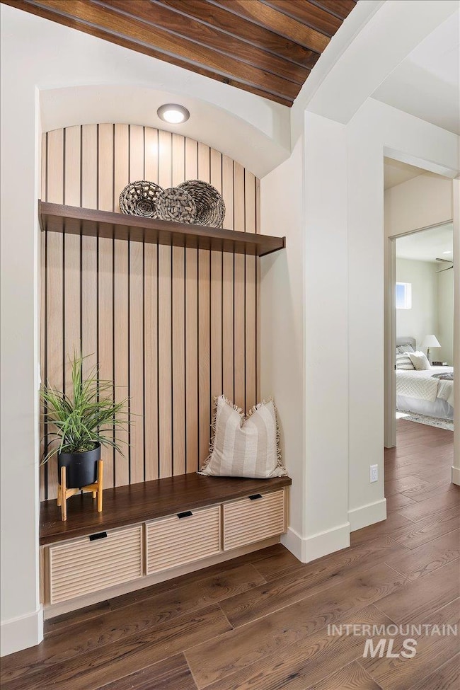 Mudroom featuring wood finished floors and baseboards