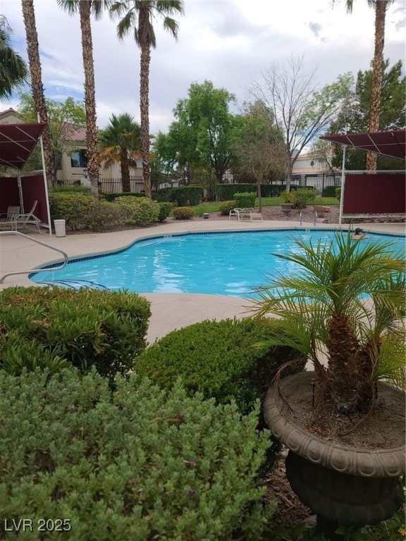 Community pool featuring a patio