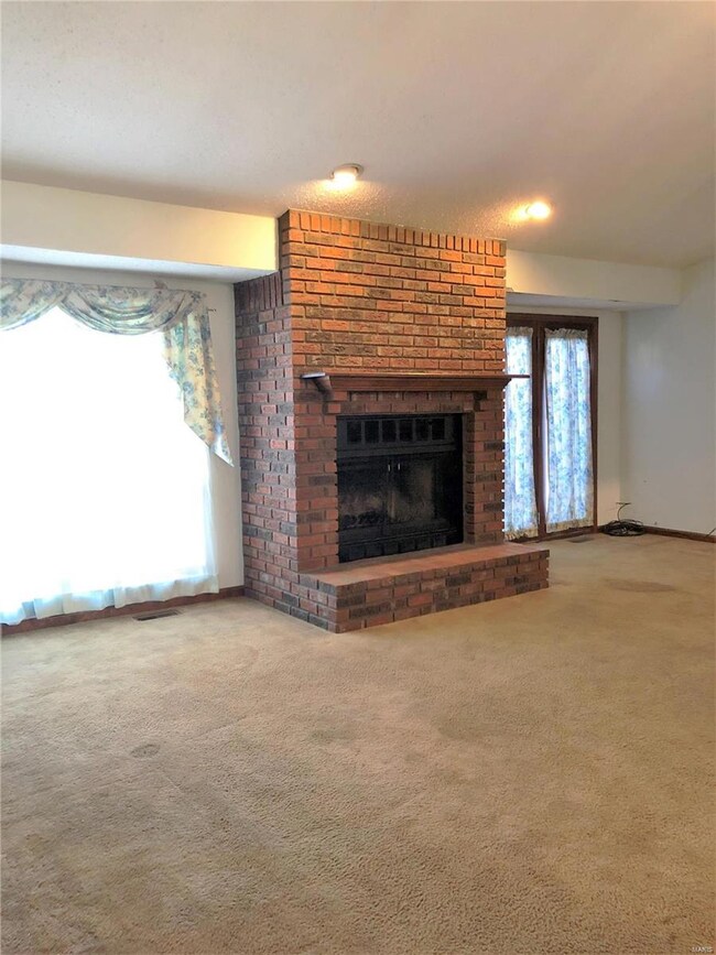 Great room with vaulted ceiling, fireplace, doors 