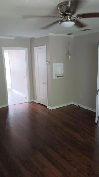 Unfurnished room featuring dark wood-type flooring