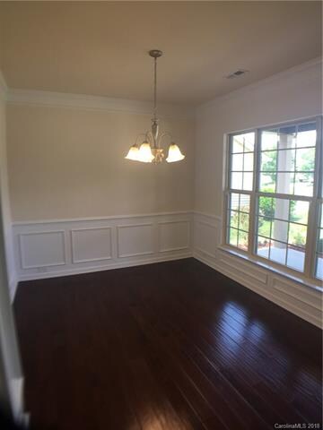 Dining room with crown molding and picture frame a